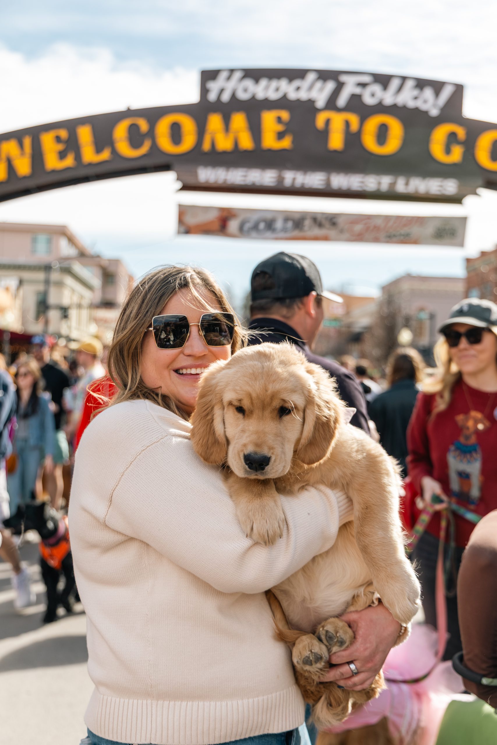 A Goldens In Golden attending holding their Golden Retriever puppy