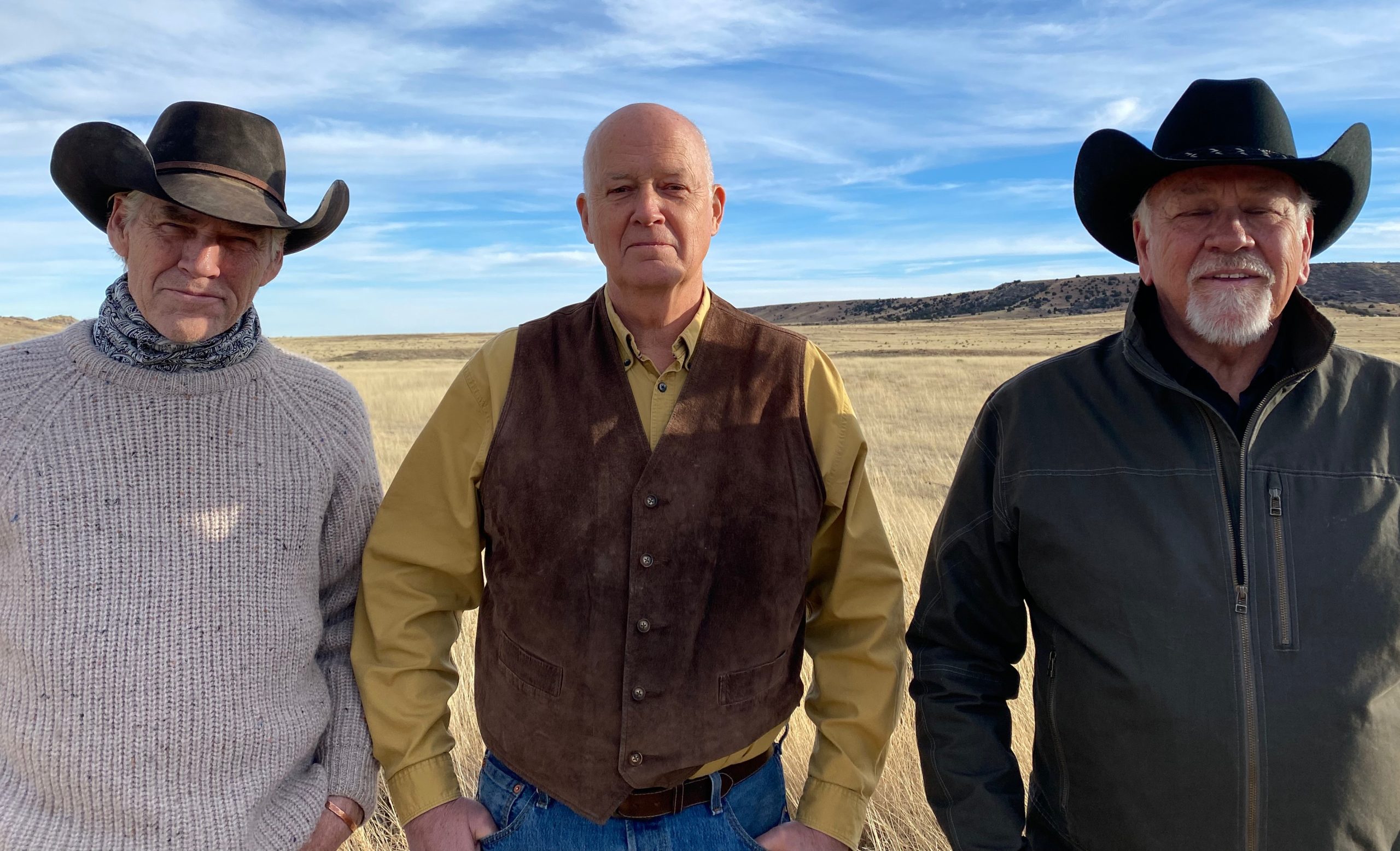 The three band members of 3 Trails West wearing traditional western clothing and cowboy hats with guitars and a stand up bass
