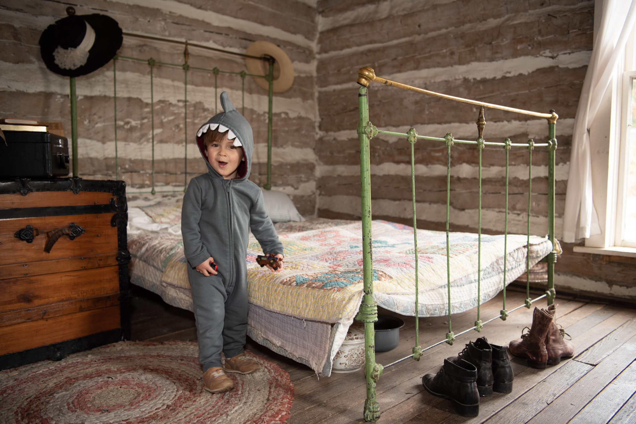 A child dressed as a dinosaur for Halloween in a cabin at the Golden History Park, photo credit Povy Kendal Atchison