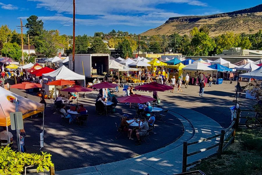 Looking out over the Golden CO farmers market vendors with North Table Mountain in the background on a sunny summer day.