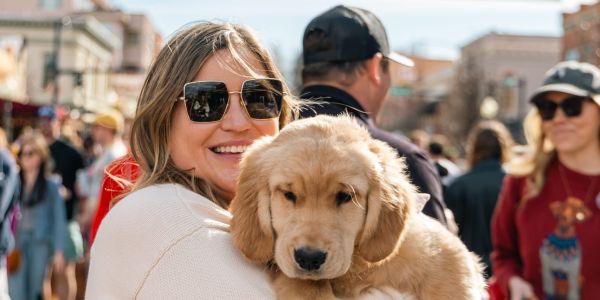 A Goldens In Golden attending holding their Golden Retriever puppy